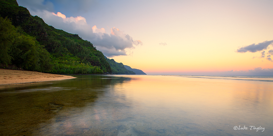 In a rare moment of low tide and low surf, Ke'e beach is transformed into a mirror at sunrise.