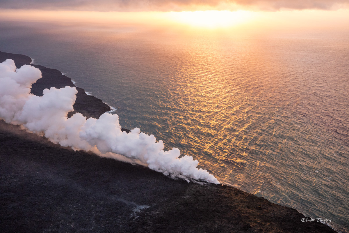 Sunrise from an open door helicopter overlooking the 61g lava entry on Hawaii's Big Island.