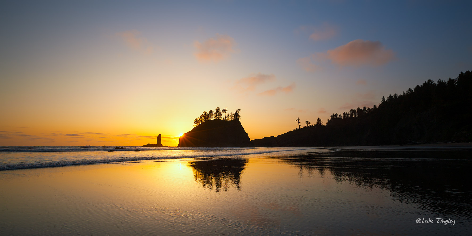 The sun sets behind sea stacks on Second Beach on the Olympic Coast.